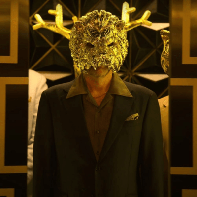 One of Squid Game's VIPs in a gold animal mask